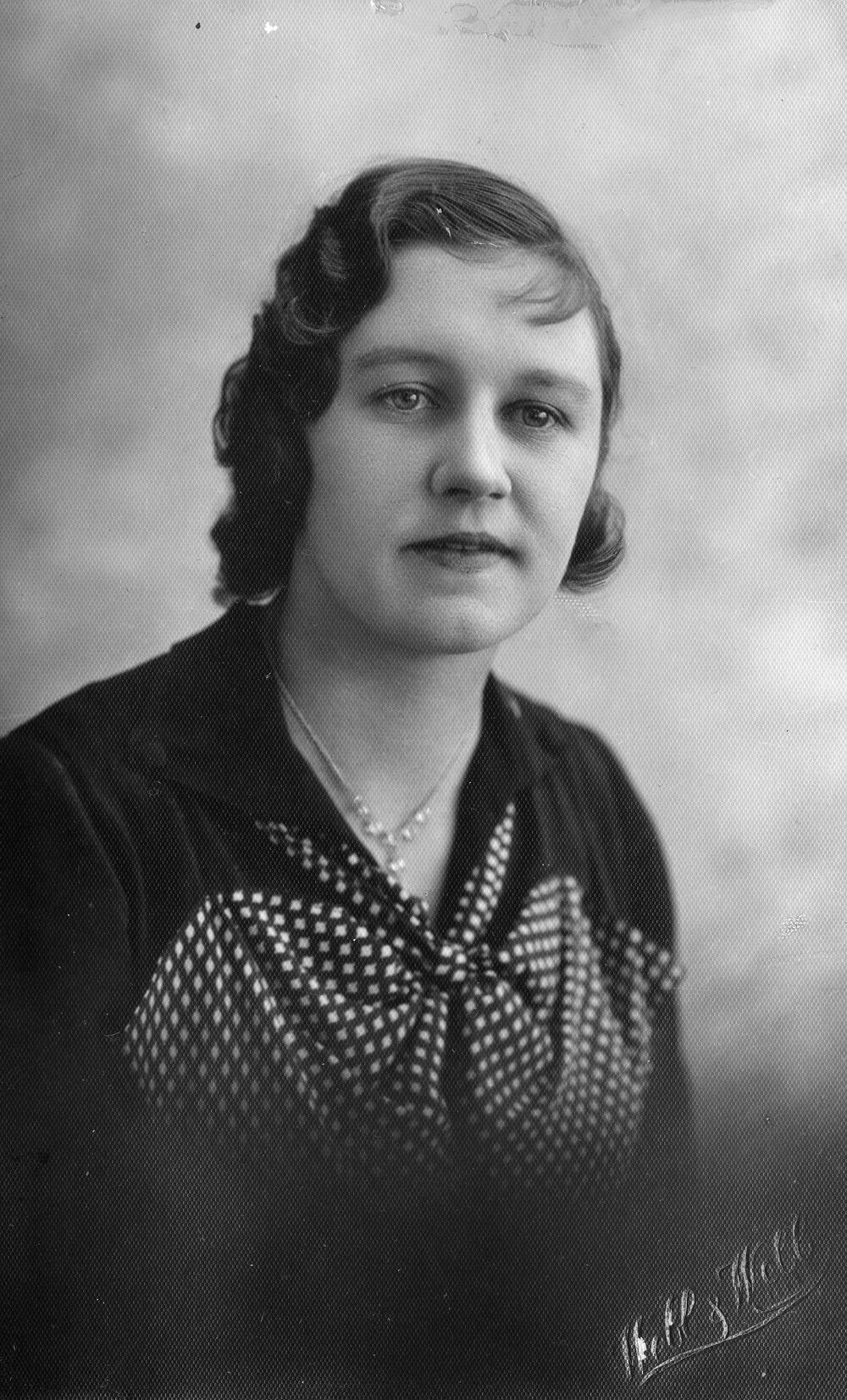 Female Ligman family member with photographer signature across corner