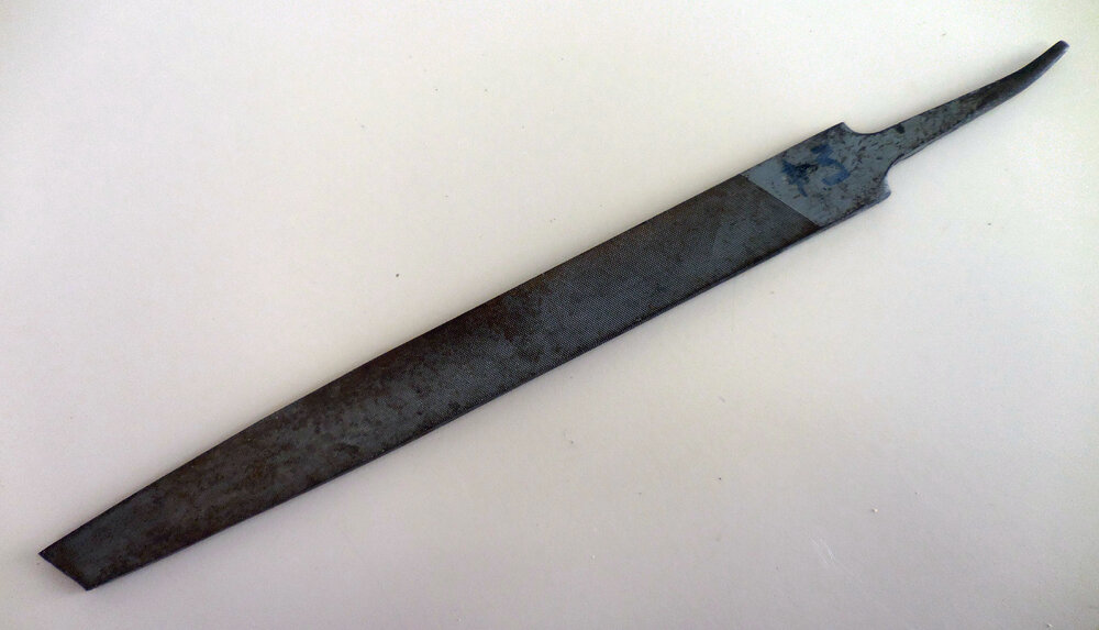 Metal rasp with curved handle tip