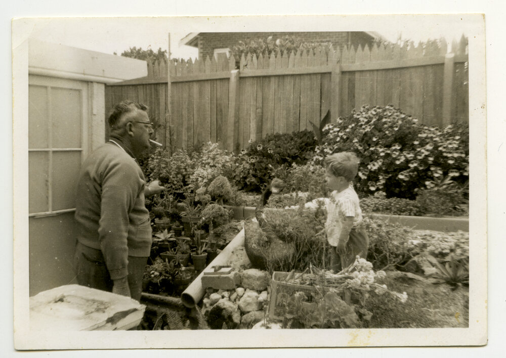 Frank Mettam in the garden of his North Beach home with grandson Todd