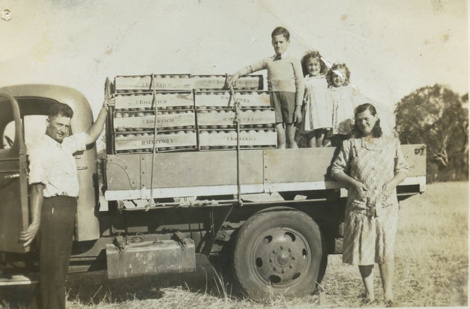 Bojanich family with truck loaded with produce