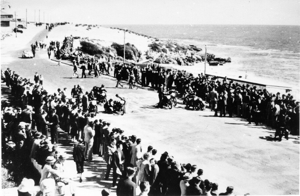 Spectators watch the Ariel Tourist Trophy race through North Beach