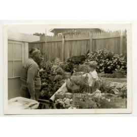 Frank Mettam in the garden of his North Beach home with grandson Todd