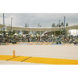 Yellow cricket pitch laid out on the sand ready for the beach cricket competition