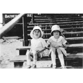 Two young girls sitting on steps at North Beach surf club