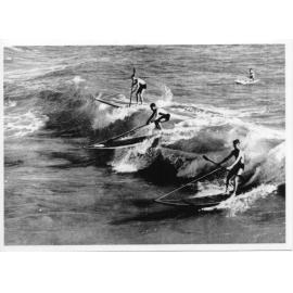 Surfing boards with paddles on ropes at Scarborough Beach 