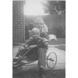 Val and Keith Strack's children playing on a home made billycart in 1962