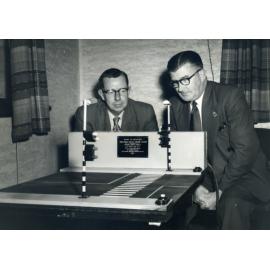 Neil Hawkins and Rus West inspect a model of pedestrian traffic lights