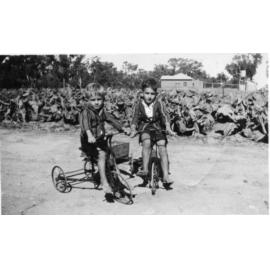 Neil and Don Arbuckle riding their bikes on the Arbuckle property