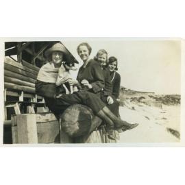 Milner family group sitting on log at North Beach