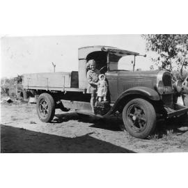 Mavis Schultz standing on side of Whippet truck 