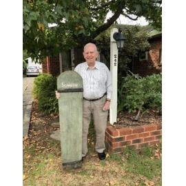 Leslie John Wearne with wooden surfboard outside his home in Scarborough
