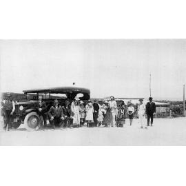 Lance's Motor Coach on North Beach Road with Willoughby Lance in white suit sixth from right 