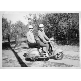 Joan Petroboni and a friend riding a moped