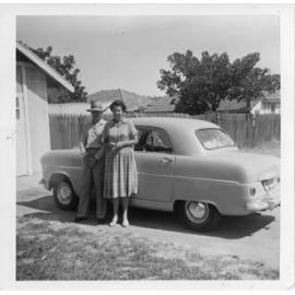 Ivy and Ronald beside their Morris 8 in their backyard in Joondanna 