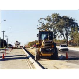 Bobcat levelling centre of island during installation on an unknown dual carriage way 