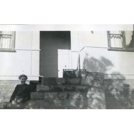 Ella Pennycuick sitting on the steps of her family home at 6 Corbertt Street in Scarborough