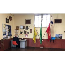Chris Denny sitting at the Weeloc House Scout Hall desk