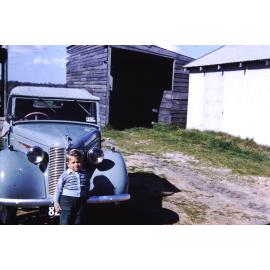 Child standing next to a car on the Stergiou family's market garden in Gwelup
