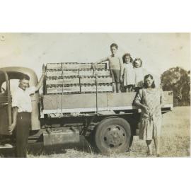 Bojanich family with truck loaded with produce