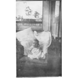 Baby sitting in a chair in the Paringa Flats, Scarborough