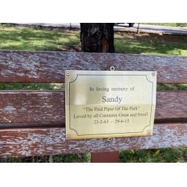 Detail of memorial bench plaque for Sandy Donnelly 