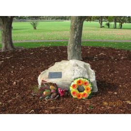 Greg Cambridge memorial plaque with floral tributes